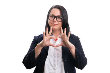 Happy female entrepreneur showing love heart gesture