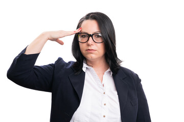Businesswoman making military salute as corporate concept