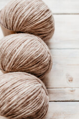 Three coils of light, skittish wool threads for close-up knitting