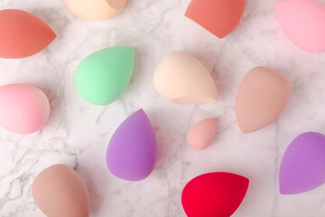 Beauty blender on marble background.Bright sponges for make-up cosmetics. Makeup products. Beauty concept. Place for text. Space for copy. Flat lay