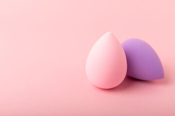 Beauty blender on a pink background.Bright sponges for make-up cosmetics. Makeup products. Beauty concept. Place for text. Space for copy. Flat lay