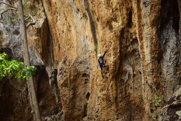 Rock climbing at Goa Pawon cliff in Bandung, West Java, Indonesia