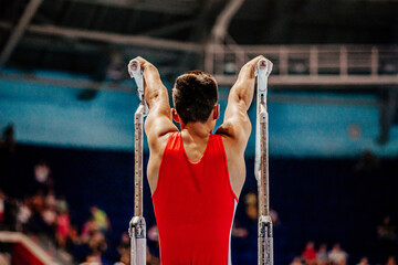 athlete gymnast exercise on parallel bars gymnastics - obrazy, fototapety, plakaty