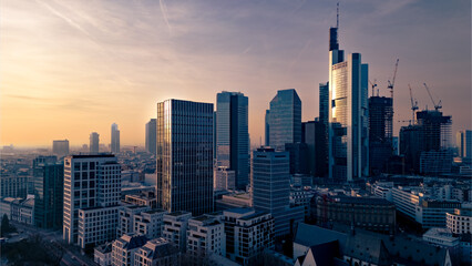 aerial view of the skyscrapers in the city against the sky at sunset © Anselm