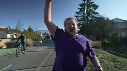 Naklejka premium One ecstatic young fat man feeling joy. Happy person celebrating success. Portrait face closeup in tracking shot of happiness concept