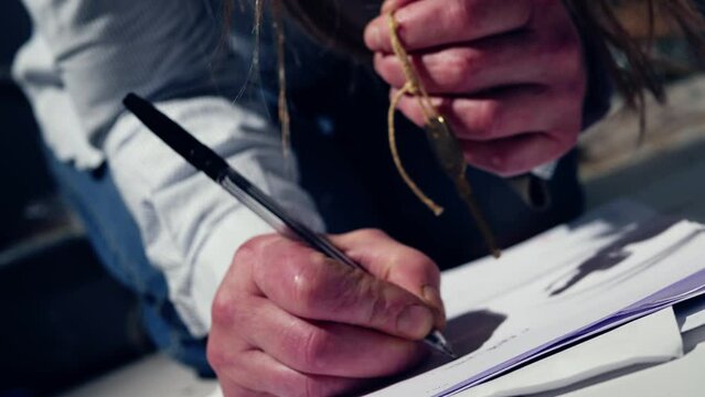 Hands holding house key writing documents 