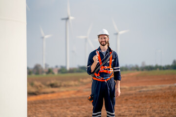 Smart engineer or technician man stand with holding light bulb and look at camera with background of windmill or wind turbine and blue sky in concept of green energy to safe the earth. © narong