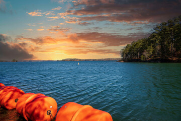 vast blue rippling water at Lake Lanier with large orange buoys in the water and lush green trees...