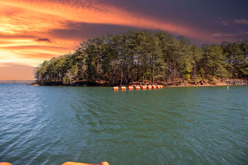 vast blue rippling water at Lake Lanier with large orange buoys in the water and lush green trees...