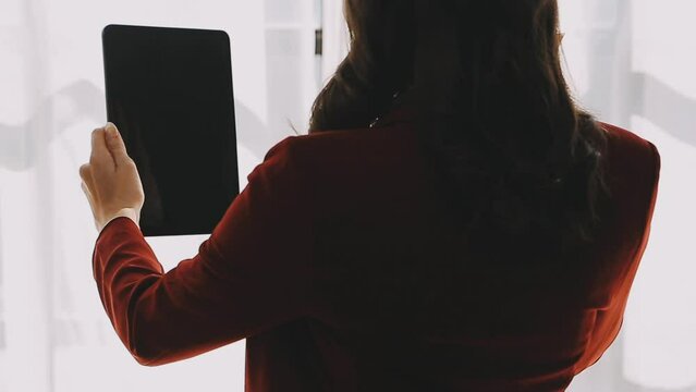 Financial analysts analyze business financial reports on a digital tablet planning investment project during a discussion at a meeting of corporate showing the results of their successful teamwork.