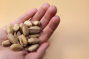 Shelled pistachios in a male hand