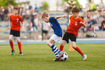 Group of young boys playing soccer game. Football match between youth soccer teams. Junior...