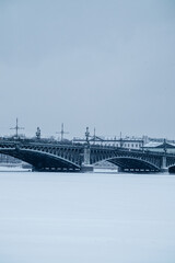 Bridge over the river and embankment in winter in a big city.