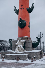 Rostral column vintage on the embankment with sculptures.