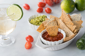 Closeup view of a small dish of homemade Keto tortilla chips served with salsa.