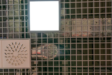Various lighting fixtures and air conditioning grilles on the ceiling of the restaurant. LED lamps on the suspended mesh ceiling. Industrial air conditioning in the large hall.