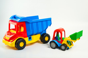 Children's toy plastic excavator and truck on a white background.