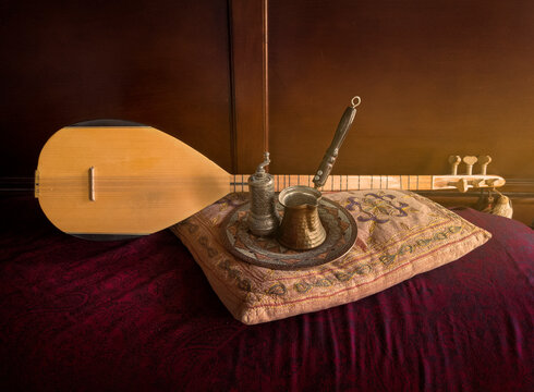 Turkish musical instrument known as a Saz or Bağlama Saz shown with a coffee grinder and pot known as a Cezve or Ibrik
