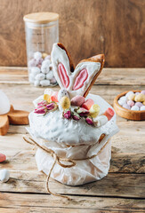 Easter Panettone with bunny ears cookies, mini chocolate eggs, marshmallows and dry roses.