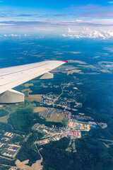 Obraz premium View from the airplane window at a beautiful cloudy sky and the airplane wing
