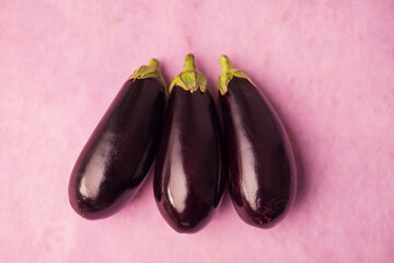 Closeup of eggplants on a pink background