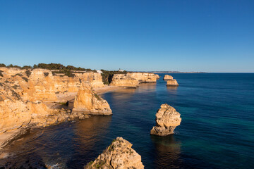 Fototapeta na wymiar Landscape of the rocky coast of the Algarve - Portugal in the evening