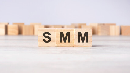 SMM - word concept written on wooden cubes or blocks on a light background