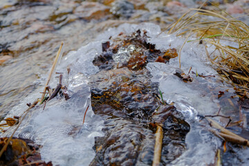 flowing stream water with bubbles and foam.