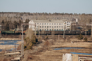 View of the autumn small town. Industrial area and railway.