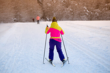 Woman cross country skiing on a sunny winter morning