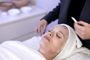 woman in cosmetic mask facial skin care rejuvenation in salon