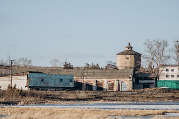 View of the autumn small town. Industrial area and railway.