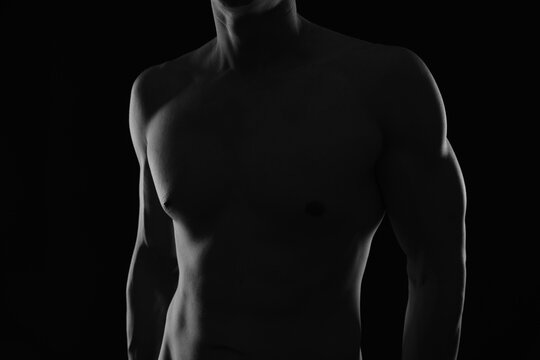 Shirtless muscular male body. Black and White Low Key Photography