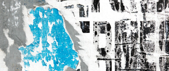Fototapeta premium Old grunge torn collage urban street posters creased crumpled paper placard texture background. Ripped faded paper backdrop surface placard