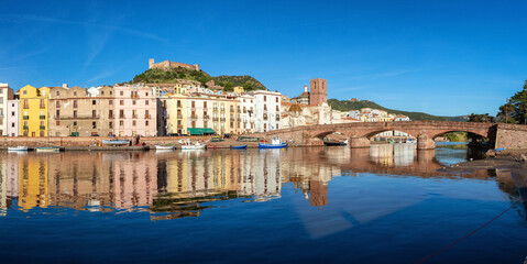 River with Homes and Apartments in Touristic Town. Bosa, Sardinia, Italy. Sunny Fall Season Day....