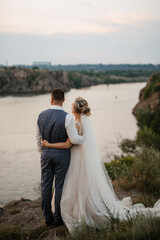 bride blonde girl and groom near the river