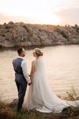 bride blonde girl and groom near the river