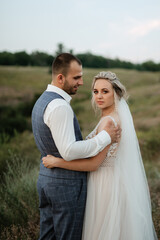 bride blonde girl and groom in a field
