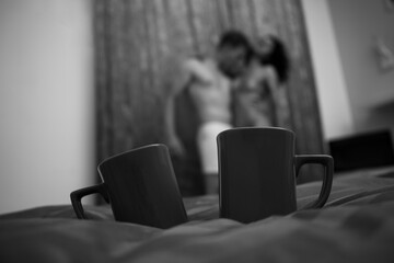 person watching tv. Sexy coffee cups. Sensual. Shadow. Man and woman. Romantic. 