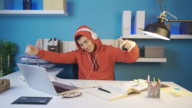 The rebellious teenager listens to upbeat music and dances wildly.
The rebellious teenager is in the cusp of puberty while listening to harsh, upbeat music with headphones.
