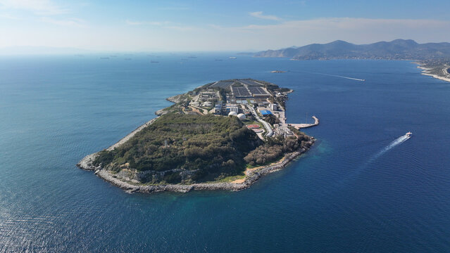 Aerial drone photo of small industrial island of Psitaleia the largest sewage treatment plant in Europe, Saronic gulf, Peiraeus, Attica, Greece