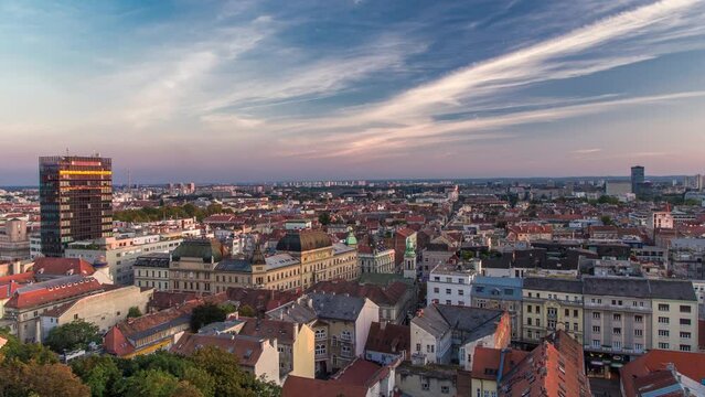 Panorama of the city center timelapse, Zagreb capital of Croatia, with mail buildings, museums and cathedral in the distance. Top view from Kula Lotrscak tower viewpoint before sunset