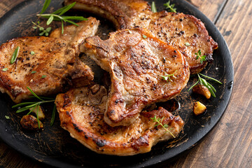 Pork chops grilled or seared bone in on a serving plate