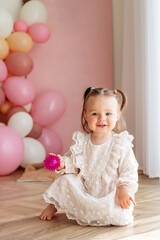 Baby toddler crawls in the room and plays with toys. Concept of childhood and Happy birthday