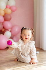 Naklejka premium Baby toddler crawls in the room and plays with toys. Concept of childhood and Happy birthday