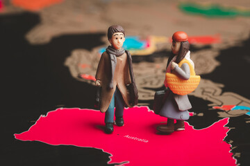 Miniature people with traveling concepts. Miniature traveler with baggage walking on the world map