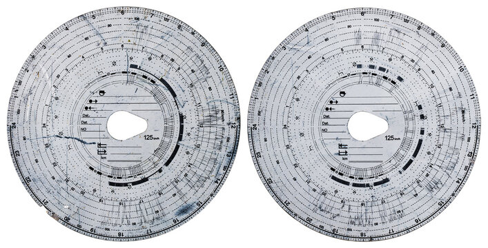 Two tachograph discs with a car driving record on an isolated background. - Powered by Adobe