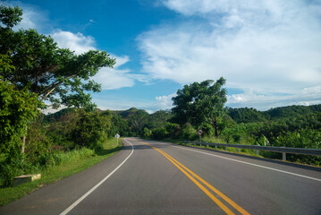Fototapeta na wymiar Highway in the Colombian countryside with a no overtaking traffic sign on the road.
