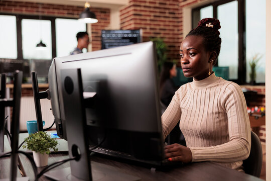 African american tech enginner typing big data code on computer, developing program using html script. Software developer writing ai algorithm working in it programming agency