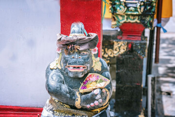 Fototapeta premium Traditional Balinesian guard statue usually placed at entry points to private or public places, close up photo